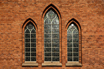 Brick wall with three vaulted windows in a row