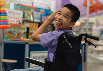 Disabled child on wheelchair trying begged parents to buy a toy for him in Books and toys...
