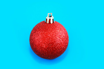 red shiny christmas ball tree toy on blue background for new year holiday