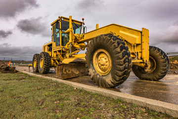 Obraz premium Excavator to level and smooth the land in the construction of a road