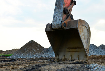 Excavator in working in a quarry. Excavator bucket. Large metal iron ladle.