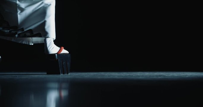 Japanese geisha in traditional kitsune costume and on geta sandals walking on stage while performing a dance - culture concept low angle close up 4k footage