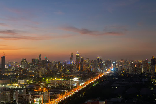Panorama of landscape with sunset over the building and blue sky at bangkok ,Thailand. View of the tall building in capital with twilight