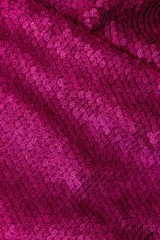 Fuchsia background. Gloss background of color fuchsia made of two-sided sequins. Closs background. Festive concept.