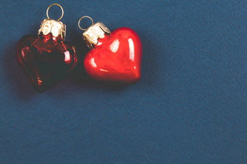 Two red hearts. Beautiful glass hearts on dark ultramarine background. Top view. Valentines Day...