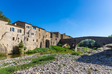 Fototapeta premium Perspective of the Romanesque bridge, was built in the 12th century. Lagrasse, Occitanie, France.