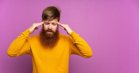 Redhead man with long beard over isolated purple background with headache