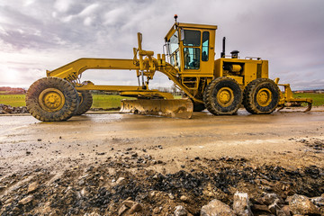 Excavator to level and smooth the land in the construction of a road