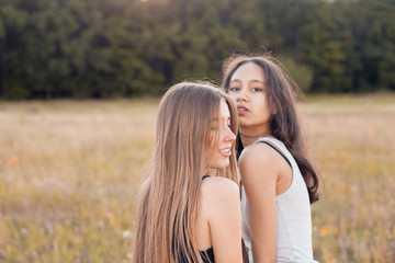 Fototapeta premium Two young women in hugging outdoors. Best friends.