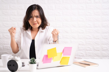 Angry woman working at office