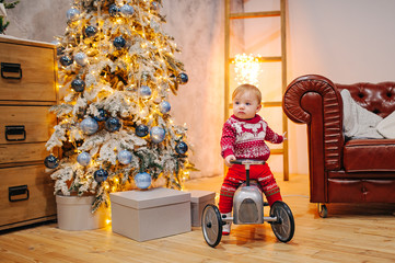 Happy fun child paying with little car at home on Christmas time. Xmas holiday concept