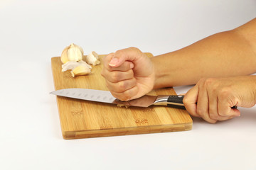 A female chef chopping garlic