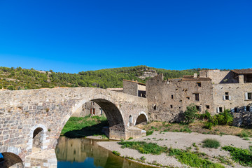 Fototapeta na wymiar Medieval vaulted arch bridge over Orbieu river in Lagrasse, France