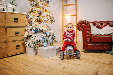 Happy fun child paying with little car at home on Christmas time. Xmas holiday concept