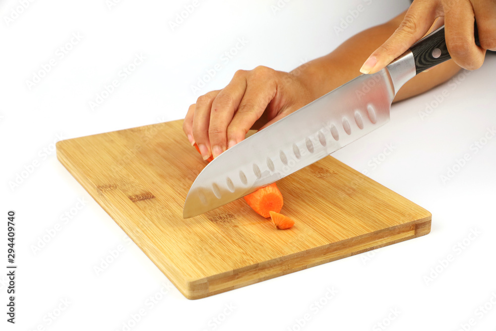 Wall mural a female chef chopping a carrot