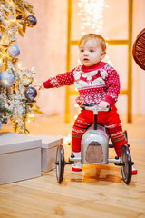 Happy fun child paying with little car at home on Christmas time. Xmas holiday concept
