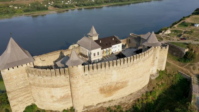 Aerial view of old castle near the River. Hotyn Castle in Ukraine. Eastern Europe. Zoom in.