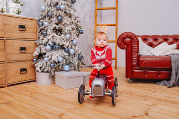 Happy fun child paying with little car at home on Christmas time. Xmas holiday concept