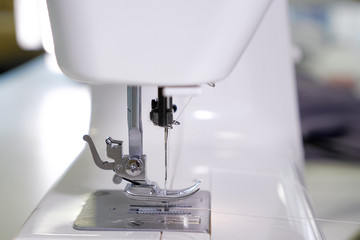 Tailoring business concept. needle in sewing machine, close-up