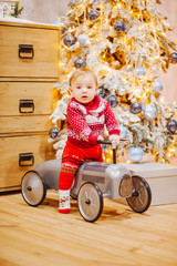 Happy fun child paying with little car at home on Christmas time. Xmas holiday concept