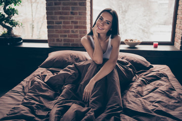 Portrait of her she nice attractive lovely charming winsome pretty dreamy cheerful cheery girl lying in bed relishing delighting enjoying holiday at industrial brick loft modern style room