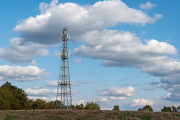 Telecommunication Tower Against Cloudy Blue Sky