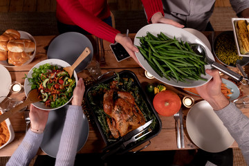 Millennial adult friends celebrating Thanksgiving together at home 