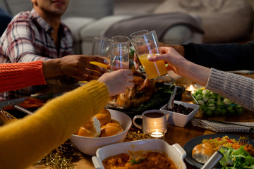 Millennial adult friends celebrating Thanksgiving together at home 