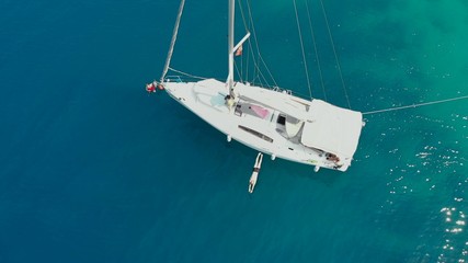 Sailing regatta, boat trip, top view. White yacht in the blue sea