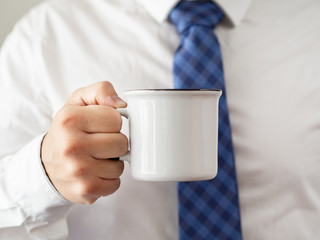 Close-up hand holding coffee mug mock-up