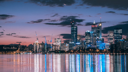 City light with sunset and moon rise together at Perth city