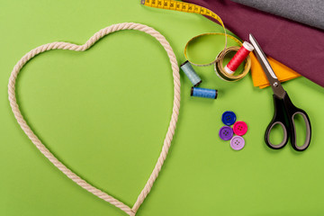 a heart of a rope button and colorful fabric with scissors