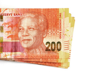 South African money, currency, orange two hundred rand notes stacked and isolated on a white background featuring Nelson Mandela