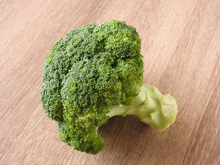 High angle view of healthy green raw broccoli isolated on wooden background. Cooking ingredients....
