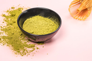 Matcha green tea powder close up on colored background