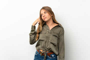 Lithuanian blonde girl over isolated white background making the gesture of madness putting finger...
