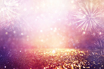 abstract gold, purple and silver glitter background with fireworks. christmas eve, 4th of july holiday concept