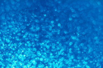 abstract blue bokeh glitter sparkle background.