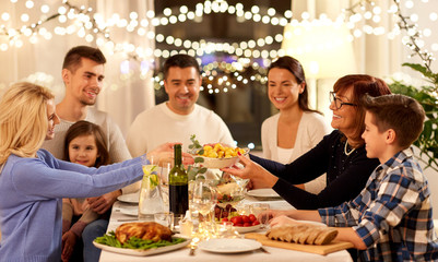 celebration, holidays and people concept - happy family having dinner party at home