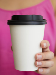 Close-up woman with pink shirt and coffee cup