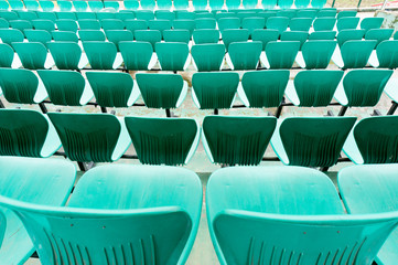 Fototapeta premium Green plastic chair rows in a cricket stadium for audience to sit on