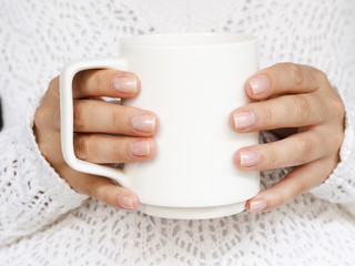 Close-up woman with sweater and white mug