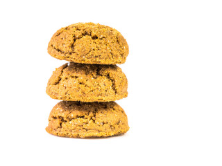 Pile of three traditional pepernoten treats on white background