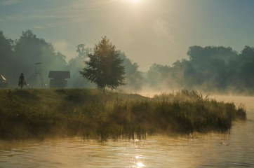 Morning on the river early morning reeds mist fog and water surface on the river.