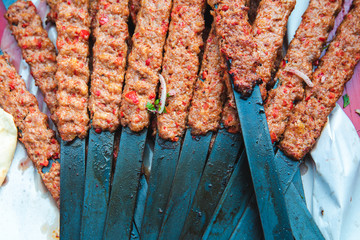 Traditional Turkish Adana Kebab or Kebap on the grill with skewers in the turkish restaurant for dinner. Turkish cuisine food culture in Turkey.