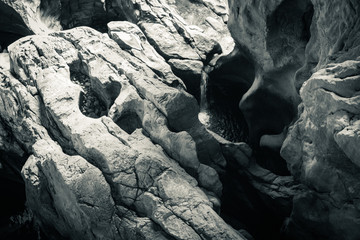walking through rocky formation in underground cave