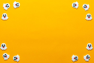 Halloween holiday concept, Spooky ghosts in orange background with copy space for text, Top flat view wallpaper