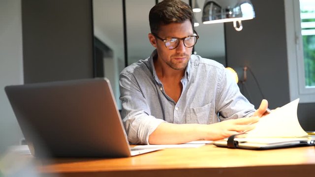 Middle-aged man working on laptop in office