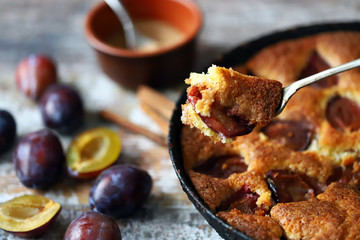 Selective focus. Slice of plum pie on a fork. Homemade American plum pie. Macro.