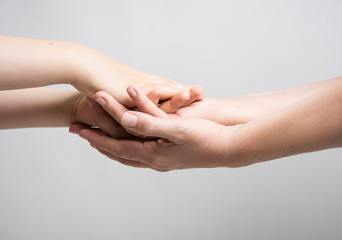 Hands holding eachother with care. Family connection. Social concept.